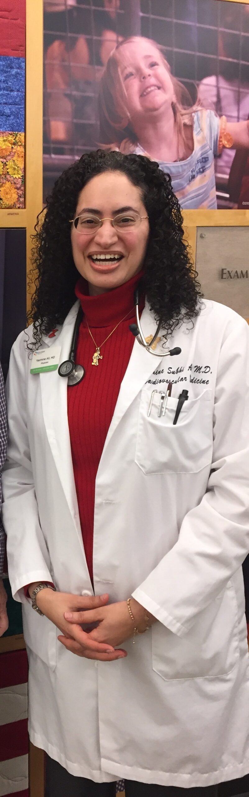Yasmine S Ali, MD smiling in white coat and wearing stethoscope at Siloam Family Health Center in Nashville, TN