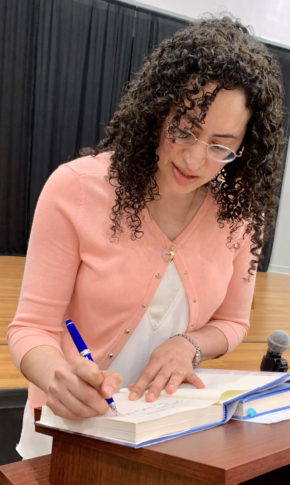 Yasmine S Ali MD signing copies of Walk through Fire at Waverly Train Disaster 45th Commemoration Event